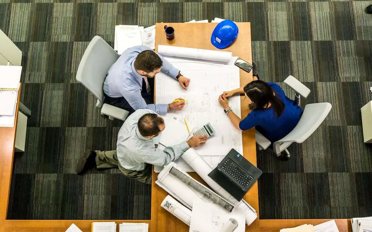 A prospective franchisee working through franchise fees and royalty calculations on a worksheet